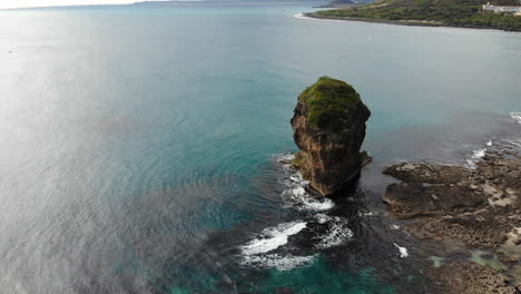 drone shote with camera circling around sail rock chuanfanshih in kenting national park in taiwan