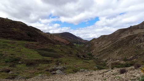 Vehicles-driving-across-scenic-rugged-majestic-rural-mountain-valley-countryside-North-Wales