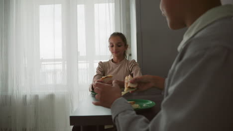woman smiling in kitchen, natural light streaming through window, cozy atmosphere, soft lighting, microwave, kettle, bottles visible, enjoying peaceful moment, relaxed home setting