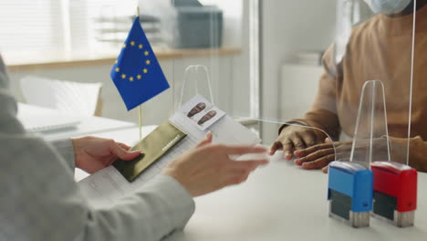 passport application at an eu office with protective barrier