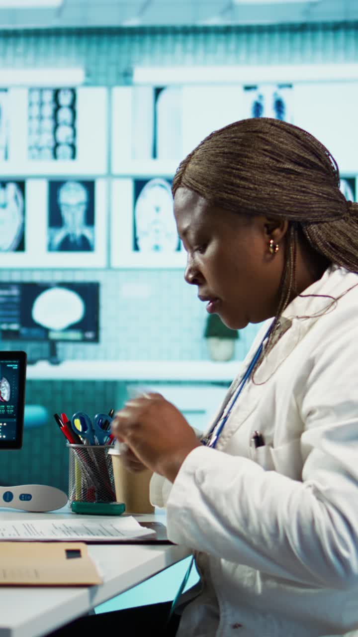 African American Doctor Working and Talking in Medical Office