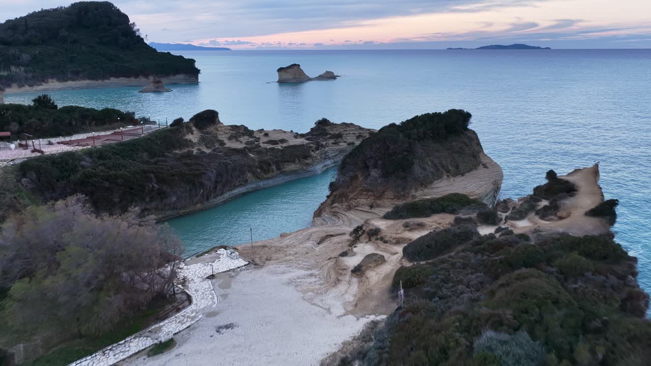 Cinematic aerial drone landscape of Canal d'Amour coastline at sunset with calm sea and distant islands, Sidari, Corfu, Greece, scenic romantic travel background