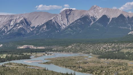 Left-to-right-drone-view-of-the-North-Saskatchewan-River-as-it-cuts-through-the-Kootenay-Plains-Ecological-Reserve,-Alberta,-Canada