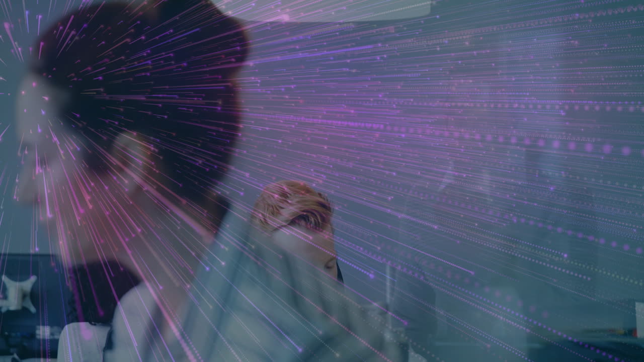 Colorful light streaks animation over people working in modern office environment