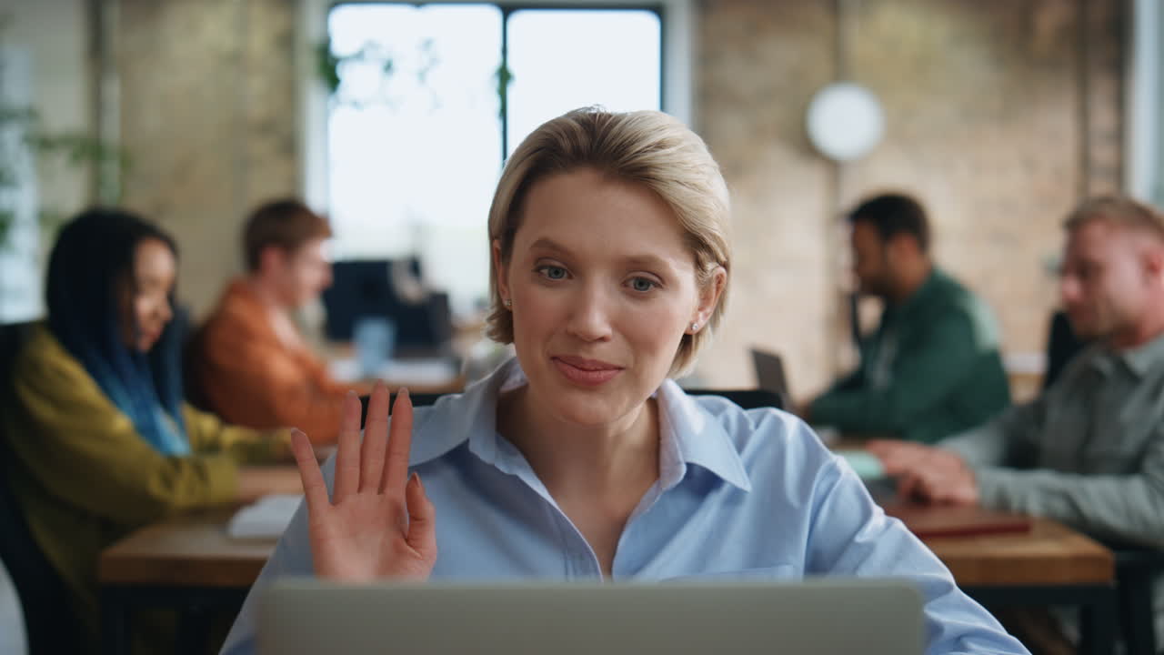 Businesswoman smiling video conference sitting office with business team closeup