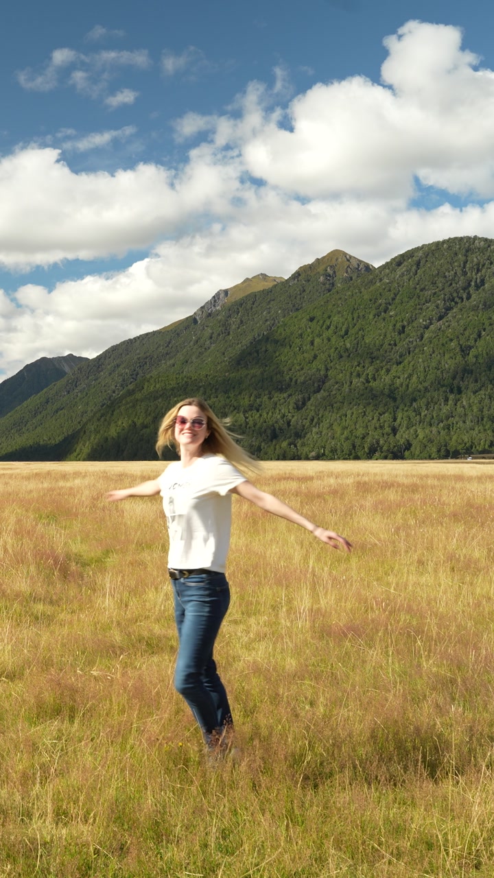 Couple taking photos in Eglinton Valley, New Zealand. Vertical