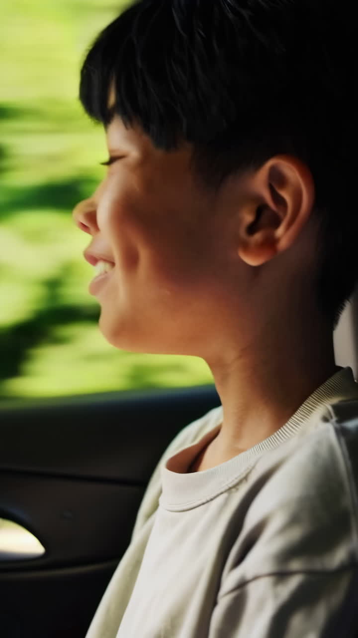 Young boy looking out of a car window