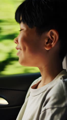 young boy looking out of a car window
