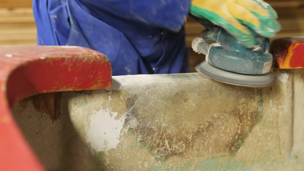 Repairing old fiberglass boat sanding transom using orbital sander