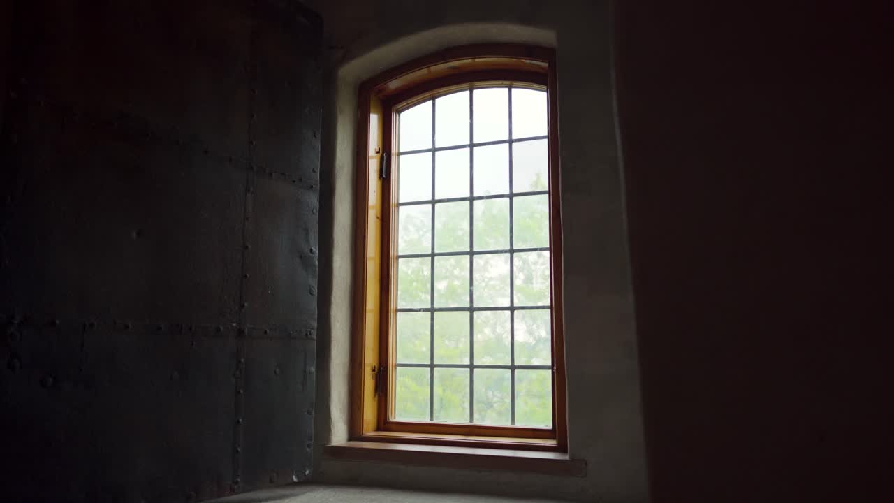 Old window with a wooden frame in a medieval castle. Reveal shot