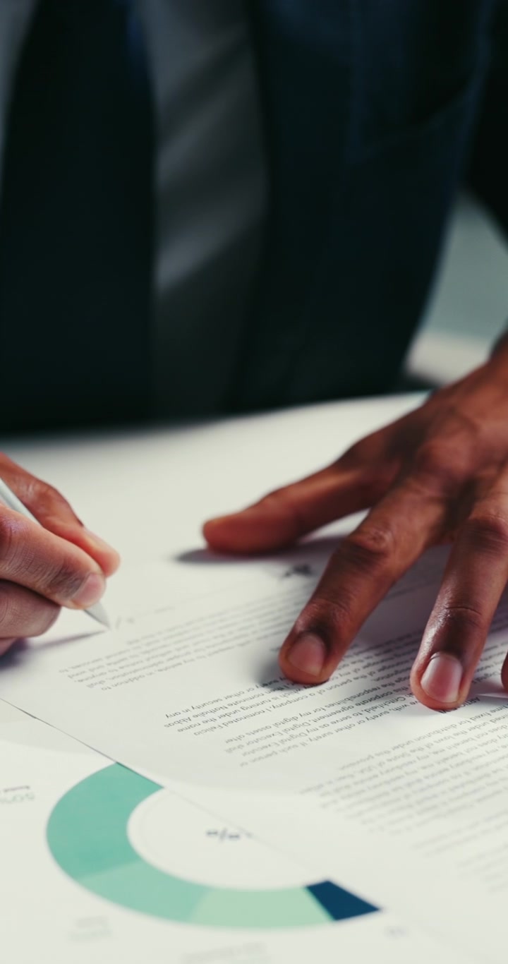 Business Professionals Signing Legal Documents in Office