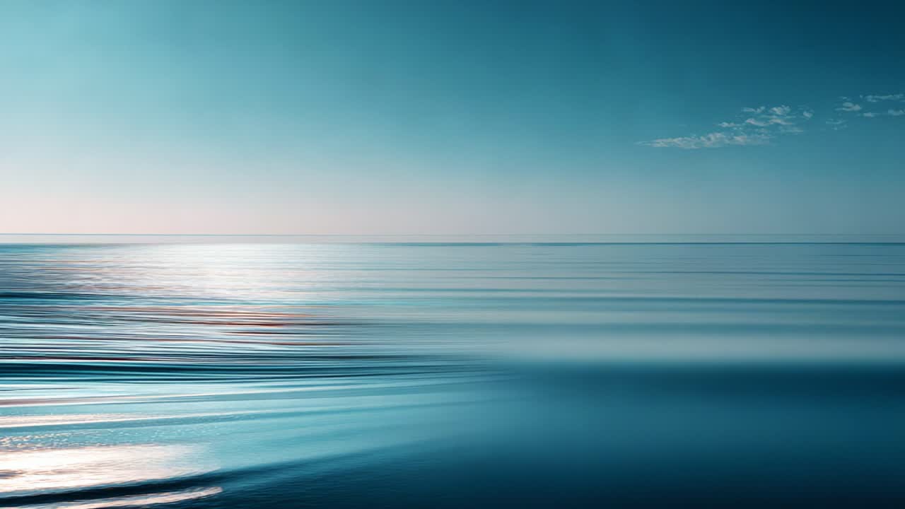 Aerial View of Tranquil Ocean Waves Under Clear Sky Highlighting Serene Water Surface and Gentle Ripples, Capturing the Essence of Peaceful Seascape at Early Morning Light