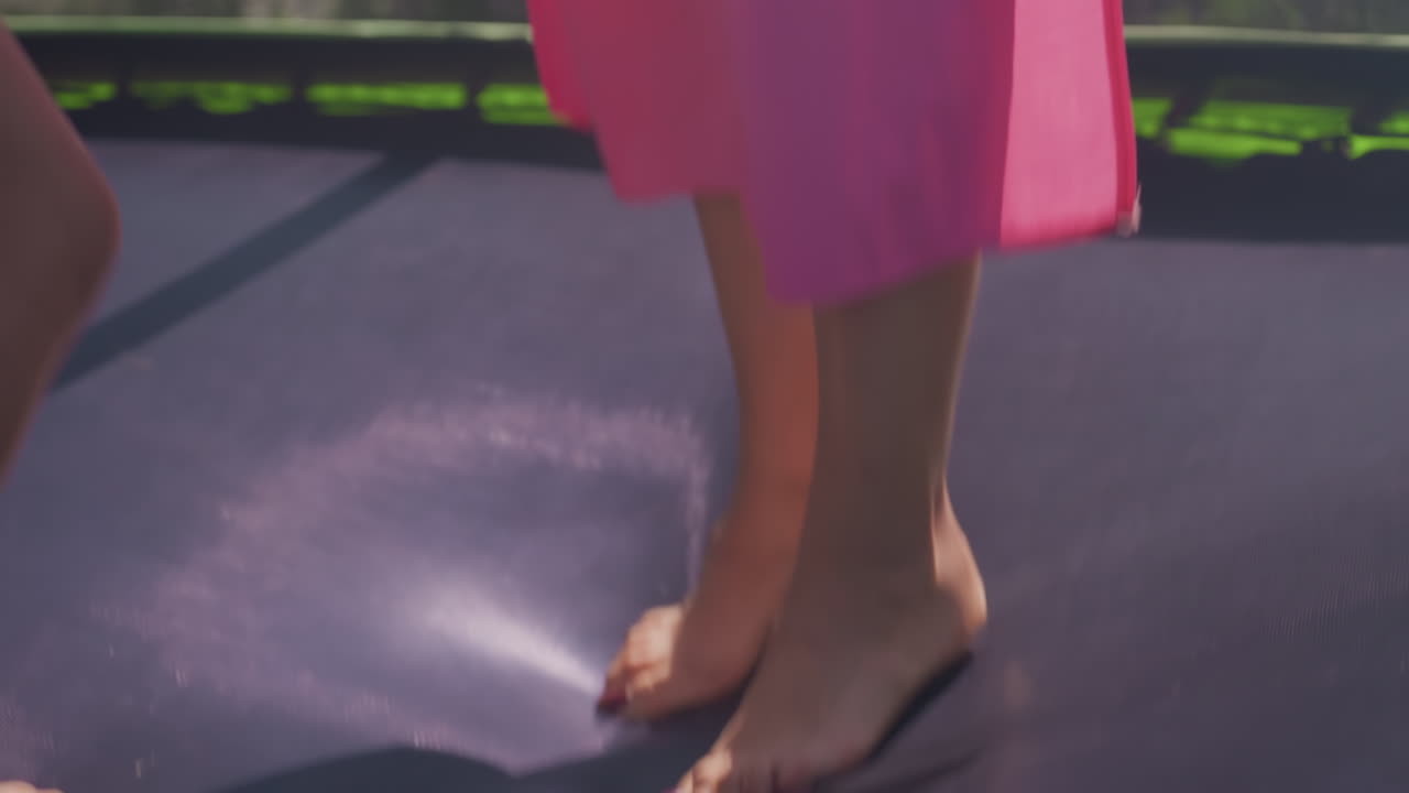 Bright Young Girl Joyfully Jumps Outdoors, Child In Colorful Attire Energetically Leaps Under Sunny Sky, Happy Child Dressed In Vibrant Clothes Playfully Jumps Outside Beneath Shining Sun