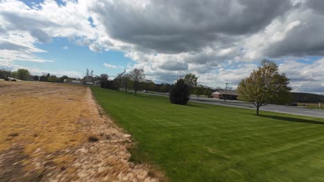 drone flies over close and over a grain field at high speed, wide angle point of view shot