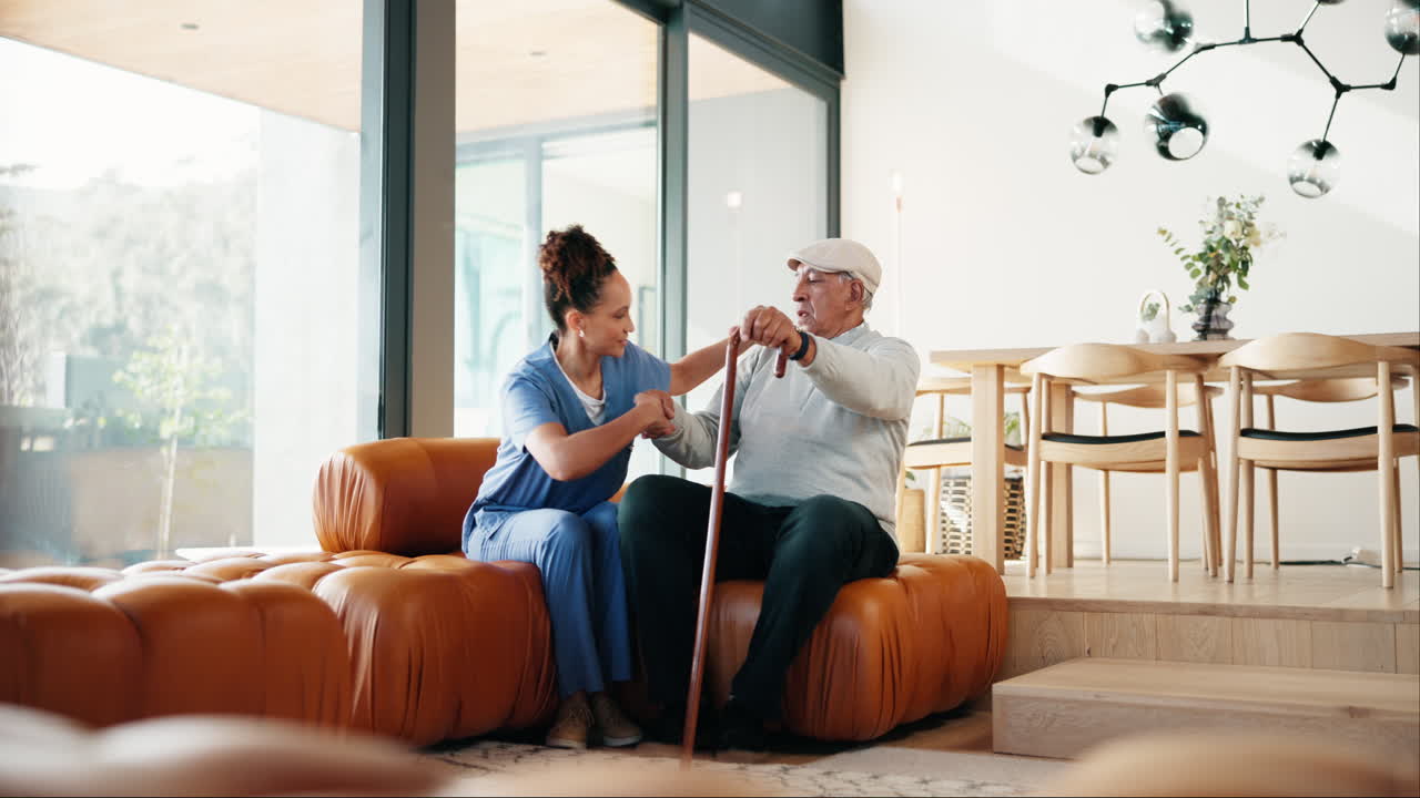 Nurse assisting elderly patient at home