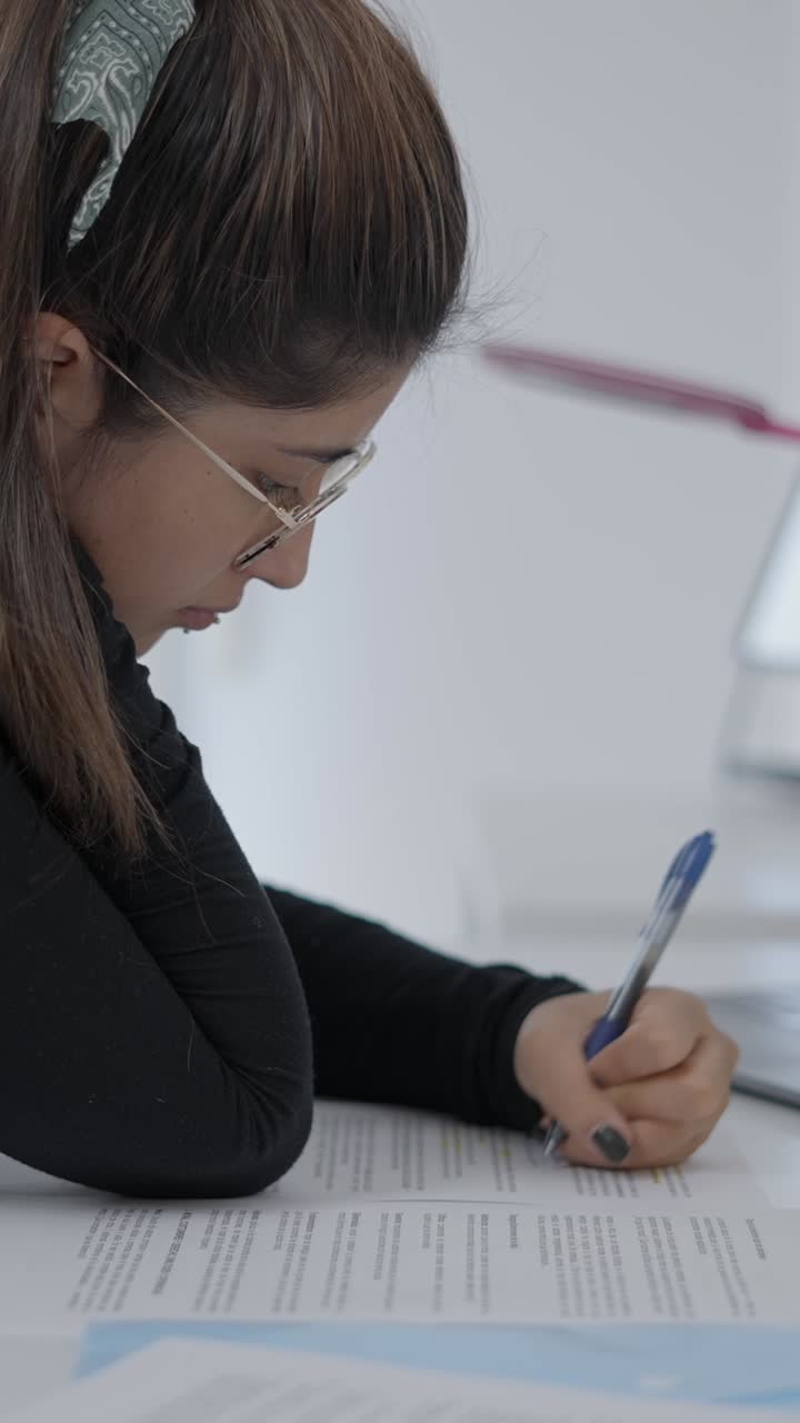 Young woman writing on paper