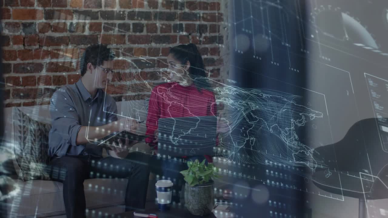 Man tapping tablet and woman opening laptop examining streaming data overlay for business analysis