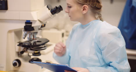 scientist examining bacteria under microscope at laboratory 4