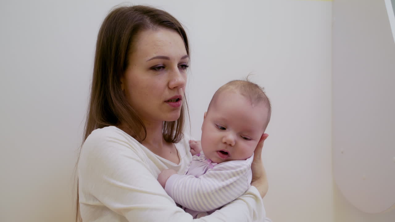 Woman with baby. Pretty woman holding newborn baby in her arms