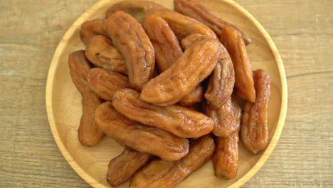 sun dried banana on wooden plate