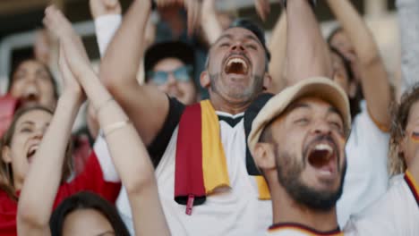 football supporters in fan zone celebrating a goal