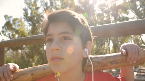 boy listening music while exercising with log in boot camp