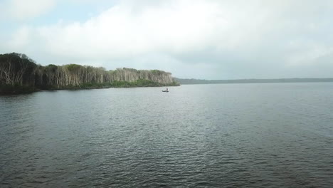 Aerial-drone-shot-flying-over-an-open-body-of-water-in-the-Rosario-Islands