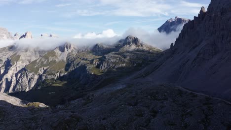 Low-clouds-covering-mountain-landscape-at-Tre-Cime-National-Park,-wide-establishing-aerial-view