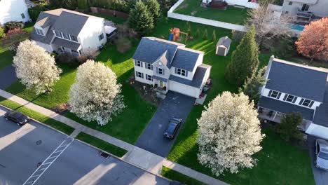 aerial top down orbit of house with kids