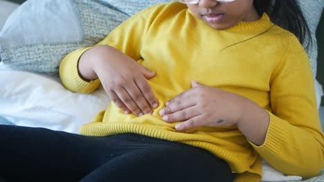 young girl holding her stomach