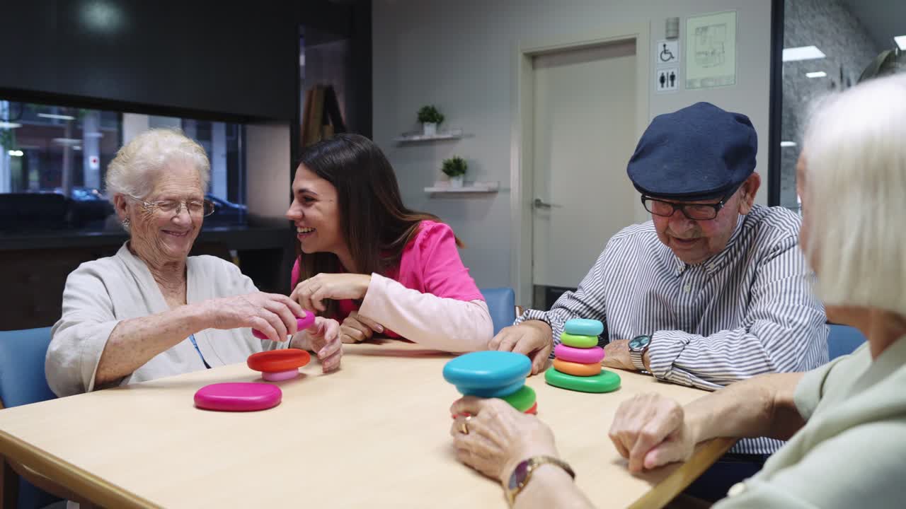 Elderly people playing game with caretaker