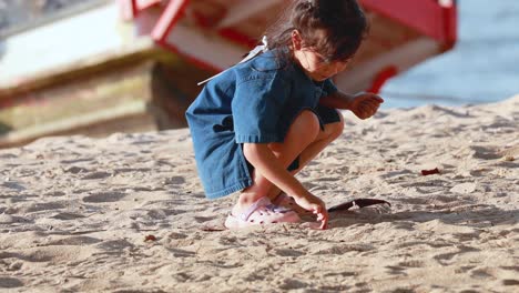 a child explores the sandy beach