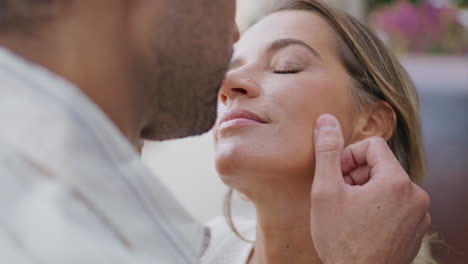 loving couple romantic kiss on nature walk closeup. man touching woman face