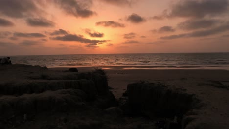 Blissful-Orange-Sunset-Skies-Above-Calm-Ocean-Waves-At-Beach-In-Balochistan