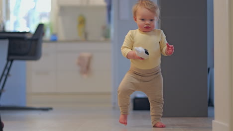 happy baby boy learning to walk at home. slow motion