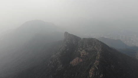 Aerial-drone-shot-of-Lion-Rock-in-Hong-Kong-on-a-foggy-day-in-October