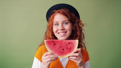 young woman holding a watermelon slice