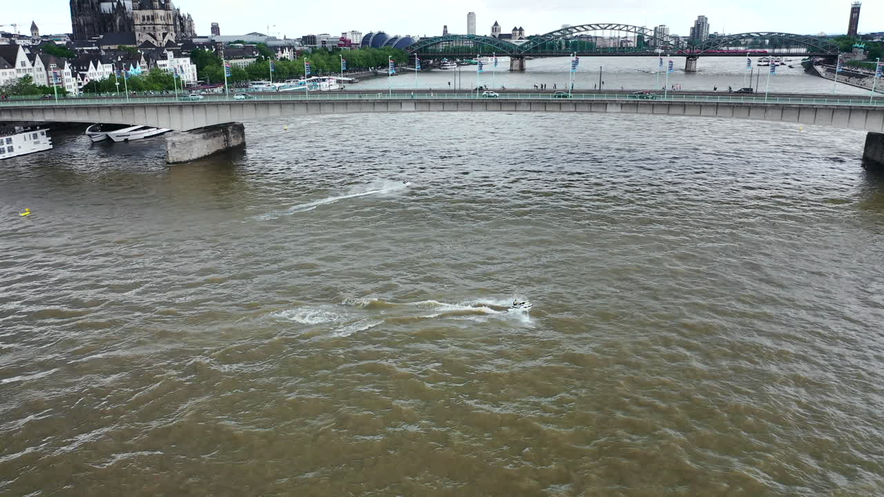 Aerial shot of drone flying above jet ski on Rhine river in Cologne