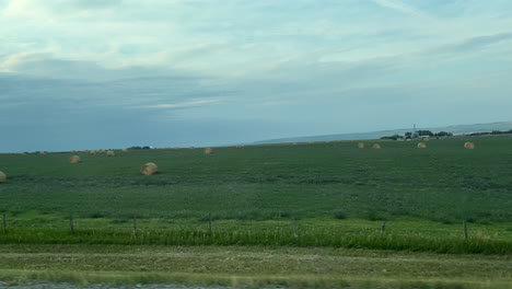 serene rural landscape with hay bales and green fields