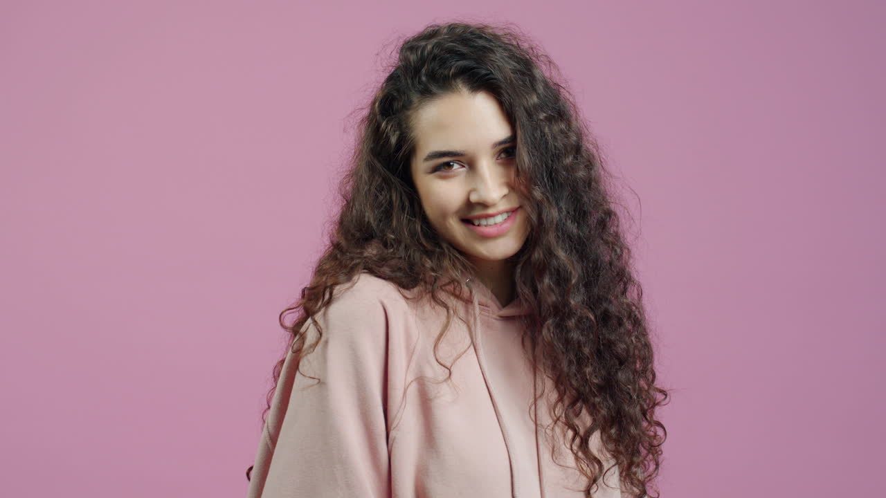 Young Woman with Curly Hair Wearing a Hoodie