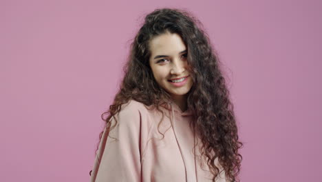 young woman with curly hair wearing a hoodie