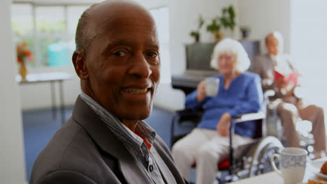 Side-view-of-African-American-senior-man-smiling-in-nursing-home-4k