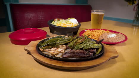 beef and chicken fajitas with peppers and onions, refried beans, mexican rice, beer, slider hd