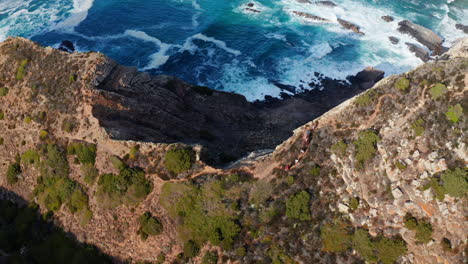 Aerial-tracking-shot-following-hiking-group-during-descent-of-mountain