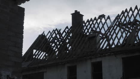 rain falling on the damaged house and old wall in northern ireland - medium shot