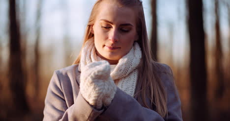 woman warming up hands in autumn