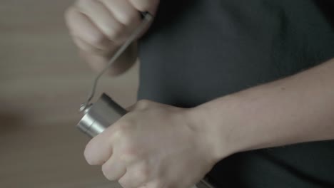 man turning the lever on a grinder - close up shot