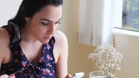 Woman-using-mobile-phone-while-having-meal-4k