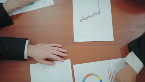 council of financial managers and directors in office closeup view of charts and diagrams on table