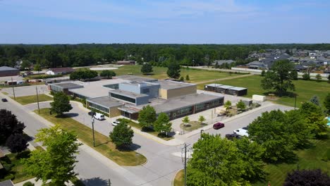 drone circling over a school on a sunny day in mount brydges